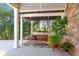 Relax on this covered patio with a wooden swing and lush greenery for outdoor enjoyment at 1967 Mason Mill Rd, Decatur, GA 30033
