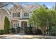 Charming two-story home featuring a stone facade, manicured landscaping, and classic architectural details at 1967 Mason Mill Rd, Decatur, GA 30033