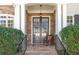Inviting entryway with a stone accent wall, a covered porch, and double doors at 1967 Mason Mill Rd, Decatur, GA 30033