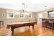 Spacious game room with a billiard table, bar, and hardwood floors for endless entertainment at 1967 Mason Mill Rd, Decatur, GA 30033