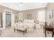 Serene main bedroom with a tray ceiling, soft lighting, and a sitting area with a comfortable bench at 1967 Mason Mill Rd, Decatur, GA 30033