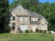 Charming two-story brick home with a well-manicured lawn and mature trees, offering great curb appeal at 3152 Meadow Glade Ct, Lithonia, GA 30038