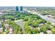 Aerial view overlooking the property, pond, trees, and highway at 41 Basswood Cir, Sandy Springs, GA 30328