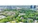 Aerial view of property, lush greenery and pond in foreground with city skyline in background at 41 Basswood Cir, Sandy Springs, GA 30328