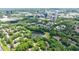 Aerial view showcases the property, lush greenery, pond, and nearby city at 41 Basswood Cir, Sandy Springs, GA 30328