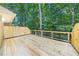Inviting wooden back deck overlooking a private, wooded lot and featuring a classic railing at 41 Basswood Cir, Sandy Springs, GA 30328