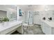 Spa-like bathroom with sleek vanities, a glass-enclosed shower, and stone tile floors at 41 Basswood Cir, Sandy Springs, GA 30328