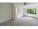 Well-lit, empty bedroom offers neutral walls, ceiling fan, carpeting, and closet at 41 Basswood Cir, Sandy Springs, GA 30328