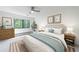 Staged bedroom boasts a natural view, neutral wall color, and ceiling fan at 41 Basswood Cir, Sandy Springs, GA 30328