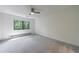 Well-lit, empty bedroom offers neutral walls, ceiling fan, carpeting, and window view at 41 Basswood Cir, Sandy Springs, GA 30328