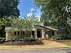 Charming home with a stone and stucco exterior, beautiful landscaping, and a welcoming entrance at 41 Basswood Cir, Sandy Springs, GA 30328