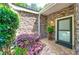 Inviting front entrance with beautiful stone detail, lush landscaping and cozy outdoor lighting at 41 Basswood Cir, Sandy Springs, GA 30328