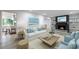 Bright living room with fireplace, white sofa, and open access to the kitchen at 41 Basswood Cir, Sandy Springs, GA 30328