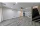 Open-concept living room featuring gray flooring and a staircase, perfect for modern living at 41 Basswood Cir, Sandy Springs, GA 30328