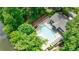 Aerial view of community pool surrounded by mature trees and overlooking the lake at 41 Basswood Cir, Sandy Springs, GA 30328