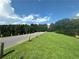 Scenic view of a road lined with green grass and trees, offering a peaceful and natural environment at 41 Basswood Cir, Sandy Springs, GA 30328
