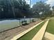 Well-maintained tennis court with benches and lush green surroundings, perfect for recreational activities at 41 Basswood Cir, Sandy Springs, GA 30328