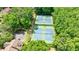 Aerial view showcasing well-maintained community tennis courts surrounded by lush trees at 41 Basswood Cir, Sandy Springs, GA 30328