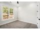 Bedroom with carpet, a ceiling fan, and a window with blinds, offering a cozy and comfortable living space at 4276 Lindsey Ne Way, Roswell, GA 30075