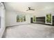 Spacious bedroom with carpet, accent wall, ceiling fan, and multiple windows overlooking the outdoor landscape at 4276 Lindsey Ne Way, Roswell, GA 30075
