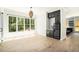 Bright dining room with hardwood floors, large windows, and a modern mini bar area at 4276 Lindsey Ne Way, Roswell, GA 30075
