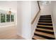 Bright entryway featuring a staircase with wooden treads and a spacious living area with large windows at 4276 Lindsey Ne Way, Roswell, GA 30075