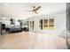 Open living room with hardwood floors, a ceiling fan, and a modern kitchen with stainless appliances at 4276 Lindsey Ne Way, Roswell, GA 30075