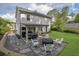 Lush backyard with a patio, a fire pit, and a well-maintained lawn at 779 Sanders Rd, Cumming, GA 30041