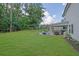 Expansive backyard with covered patio, fire pit, and ample green space for outdoor activities at 779 Sanders Rd, Cumming, GA 30041