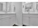 Dual vanity bathroom featuring two large mirrors, white cabinets, and quartz countertops at 779 Sanders Rd, Cumming, GA 30041