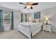 Serene bedroom with large windows, soft lighting, cozy bedding, and elegant decor, including flower artwork at 779 Sanders Rd, Cumming, GA 30041
