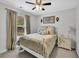 Cozy bedroom featuring a white metal bed frame, decorative accents, and a ceiling fan at 779 Sanders Rd, Cumming, GA 30041