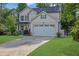 Inviting two-story home featuring a manicured lawn and attached two-car garage at 779 Sanders Rd, Cumming, GA 30041