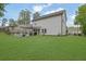 The home boasts a spacious backyard, complete with a covered patio, fire pit and well manicured lawn at 779 Sanders Rd, Cumming, GA 30041