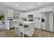 Bright kitchen with stainless steel appliances, white cabinetry, and kitchen island at 779 Sanders Rd, Cumming, GA 30041