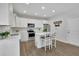 Bright kitchen with white cabinets, stainless steel appliances, and a cozy breakfast nook with barstool seating at 779 Sanders Rd, Cumming, GA 30041