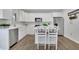 Modern kitchen with stainless steel appliances, white cabinets, and central island at 779 Sanders Rd, Cumming, GA 30041