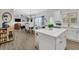 Open-concept living area with dining and kitchen, featuring modern decor, ample natural light, and hardwood floors at 779 Sanders Rd, Cumming, GA 30041