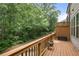 Back deck with wood railing, string lights, and peaceful wooded backdrop at 1188 Parktown Dr, Mableton, GA 30126