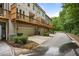 Rear exterior view of townhomes showcasing private garages and charming wooden balconies at 1188 Parktown Dr, Mableton, GA 30126