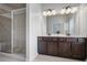 Bathroom featuring a double vanity, large mirror, and glass shower at 1188 Parktown Dr, Mableton, GA 30126