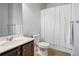 Bathroom showcasing a vanity with white countertop, a toilet, and a shower with a white curtain at 1188 Parktown Dr, Mableton, GA 30126
