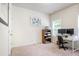 Comfortable carpeted bedroom featuring white walls and a dedicated workspace at 1188 Parktown Dr, Mableton, GA 30126