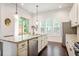 Open kitchen features granite countertops, stainless steel appliances, and a breakfast bar at 1188 Parktown Dr, Mableton, GA 30126