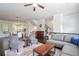 Spacious living room with hardwood floors, elegant furniture, and seamless flow to dining area at 1188 Parktown Dr, Mableton, GA 30126