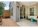 Outdoor patio area with gray siding, wood fence and wood patio with furniture at 1188 Parktown Dr, Mableton, GA 30126
