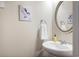 Charming powder room features stylish round mirror and convenient towel ring at 1188 Parktown Dr, Mableton, GA 30126