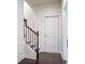Stairway with wood flooring, white painted walls and wooden banister at 1188 Parktown Dr, Mableton, GA 30126