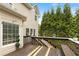 Exterior shot of the wooden deck with built in bench, overlooking the backyard, surrounded by tall trees at 1274 Ridge Vista Ct, Lawrenceville, GA 30043