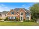 Charming two-story brick home with a manicured lawn, colorful landscaping, and blue shutters at 1274 Ridge Vista Ct, Lawrenceville, GA 30043